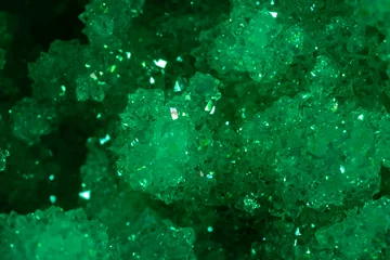 Poster Green crystal mineral stone. Gems. Mineral crystals in the natural environment. Texture of precious and semiprecious stones. Seamless background with copy space colored shiny surface of precious stone © Vera