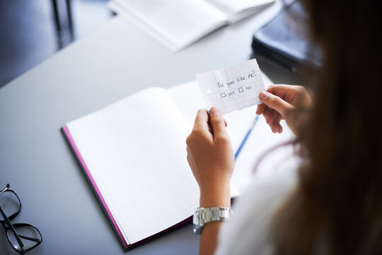Secret, note and student with love letter in class at high school with girl and social communication. Hand, paper and teenager with checklist, information or romantic question in classroom from crush