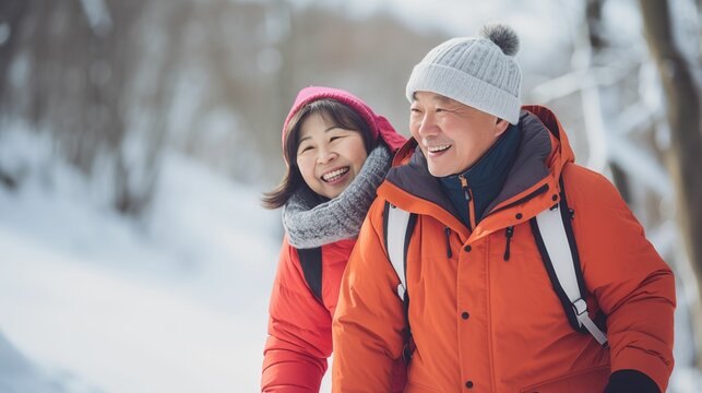 An image of an elderly Asian couple wearing cozy winter clothes.
