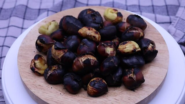 Roasted chestnuts rotating on a turntable.
