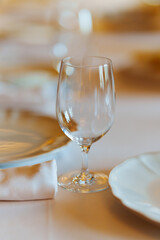 An empty wine glass on a table served for a banquet. 