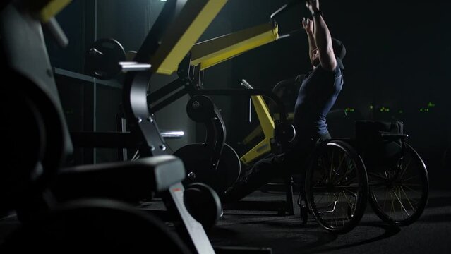 Fortitude and motivation, disabled athlete in wheelchair lifting blocks on a gym machine, strength training on block device, people with disabilities, cinematic lighting.