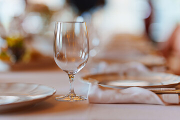 An empty wine glass on a table served for a banquet. 