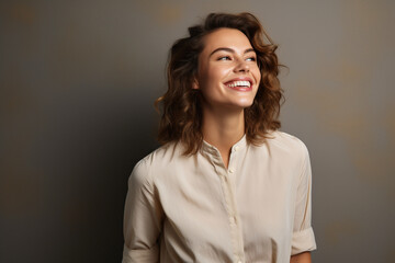 Obraz premium Radiant Glow: Happy Young Woman Gazing Away with a Joyful Smile, Standing Confidently in a Studio Background, Capturing a Moment of Contentment