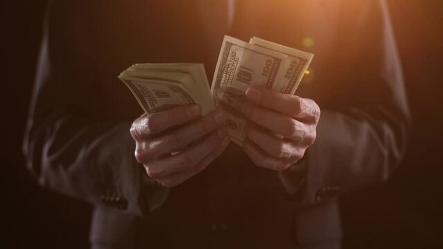 Hands of a financial worker counting money bills. A large bundle of money close-up.