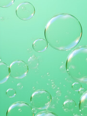 Transparent abstract soap bubbles on pastel green background 