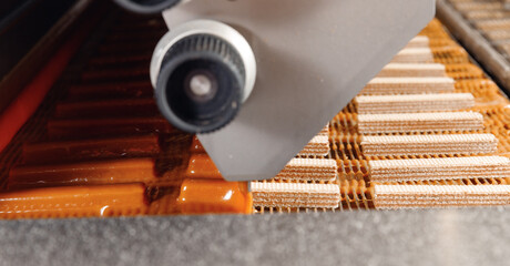 Food industry, wafer production line of modern sweet candy bakery factory. Chocolate pour on...