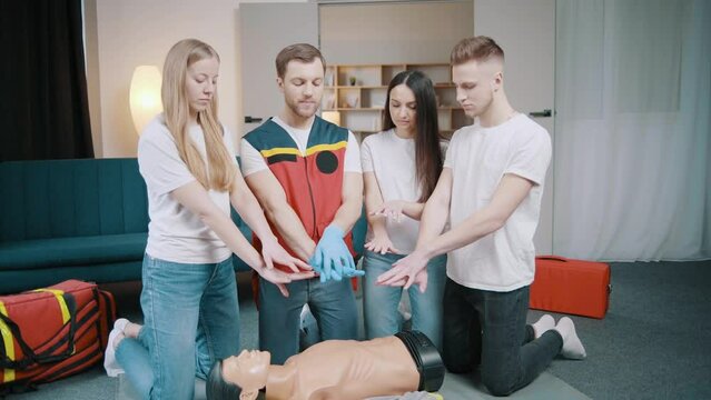 First aid resuscitation, CPR training. Students study in front of a dummy. Medicine, healthcare and medical concept