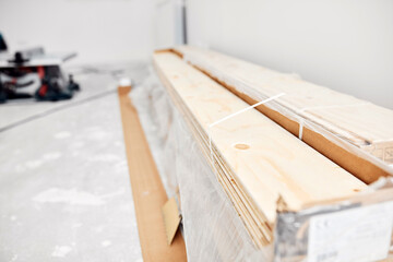 Hardwood laminate floor on a construction site ready for installing.