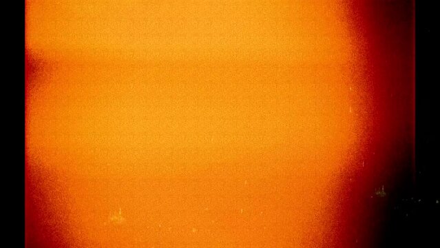 Photo filmstrip frame orange light leak and noise flickering background, backdrop, graphical resource in 4k, 35mm negative look	
