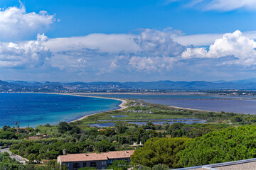 Aerial view of Giens Peninsula on a sunny spring day with Mediterranean Sea and mountain panorama in the background. Photo taken June 10th, 2023, Giens, France.