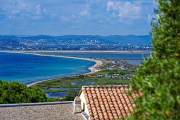 Aerial view of Giens Peninsula on a sunny spring day with Mediterranean Sea and mountain panorama in the background. Photo taken June 10th, 2023, Giens, France.