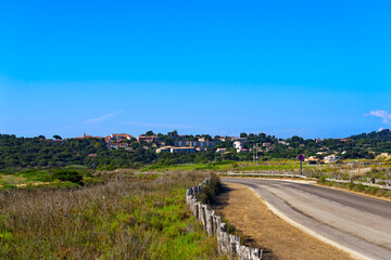 Fototapeta na wymiar cenic view at Giens Peninsula with diminishing perspective of rural road on a sunny late spring day. Photo taken June 10th, 2023, Giens Peninsula, Hyères, France.
