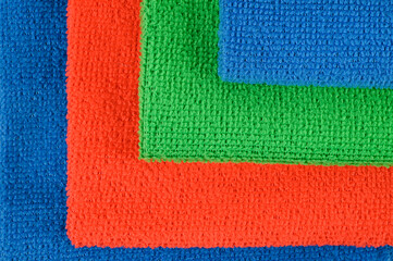 Beautifully laid out colored microfiber cloths. View from above.