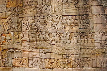 Fototapeta na wymiar War scene carved on Bayon temple outer gallery. In the center of Angkor Thom , Siem Reap, Cambodia. UNESCO World Heritage Site. Capital city of the Khmer empire built at the end of the 12th century