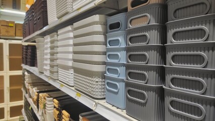 Several stack of plastic basket displayed on the rack of supermarket to attract the customer to buy