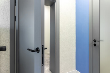 Grey door with glass insert in office building