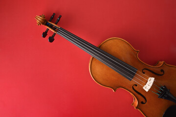 Traditional violin cut diagonally on isolated gradient romantic red background