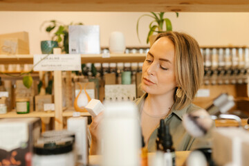 Blond woman choosing beauty products in store