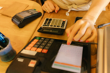 Saleswoman working at checkout counter in zero waste store