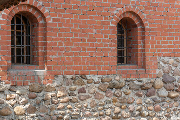  Window with bars in the fortification wall of a medieval Lida Castle.