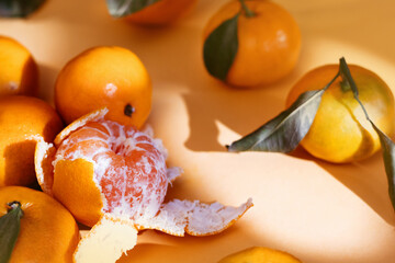 Fresh ripe mandarins on orange background with shadow