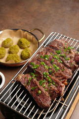 Grilled striploin beef steak served on grill, indoors