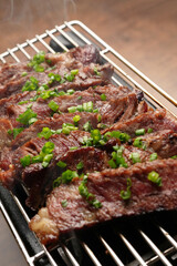 Grilled striploin beef steak served on grill, indoors