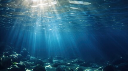 blue gentle waves The ocean surface is visible from underwater rays of sunlight penetrating through...
