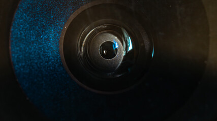 Round lens of a deteriorated mobile phone. Close-up photo of a smartphone camera lens, detaching...