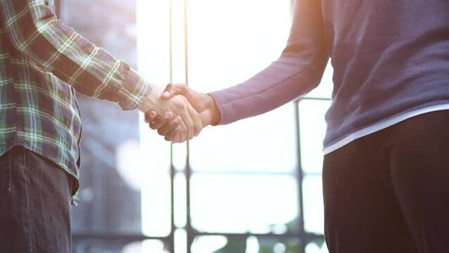 african black businessman handshaking white partner congratulating with successful dea