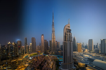 Seamless night to day sunrise transition view of the modern Downton city skyline of Dubai, UAE