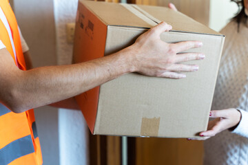 Closeup of a cardboard box. Home delivery. - obrazy, fototapety, plakaty