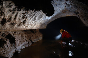 Cave explorer, spelunker, archeologist stuydying underground passage