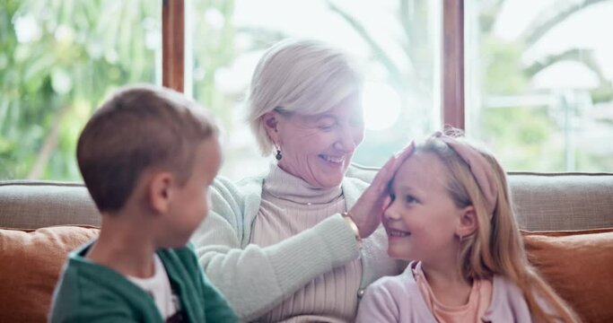 Happy, love and children hugging grandmother on a sofa in the living room at modern home. Smile, bonding and young kids embracing senior woman in retirement with care in the lounge of house.