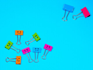 Diversity, difference or emotion concept. Funny smile metal binder clip. Multicolored emotion...