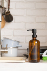 Recycled plastic pump bottle for mockup on white brick wall background near sink