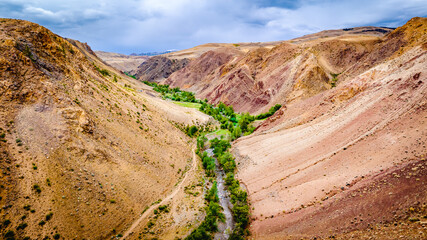 Martian landscapes in the Altai Mountains. Red colorful mountains in Altai, Siberia, Russia. Kyzyl-Chin valley, also called as Mars valley. Natural texture of sandstone.