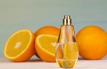 Perfume with citrus extracts. Selective focus. Spa day, concept of freshness perfume bottle with lemon lime and orange slices