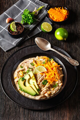 white chicken chili with cheese, avocado in bowl
