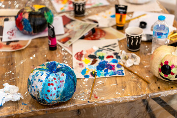 Children's painting class. Painting day with parents in class painting pumpkins.