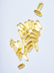 Flat lay Omega 3 golden translucent pills on flat background