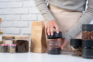 woman Reusing Glass Jars To Store Dried Food Living Sustainable Lifestyle At Home
