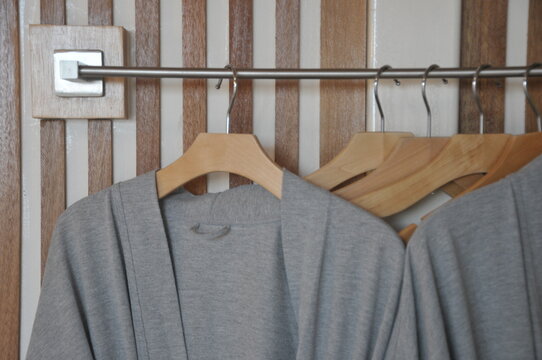 Bathrobe and Wooden Hangers in walk in closet