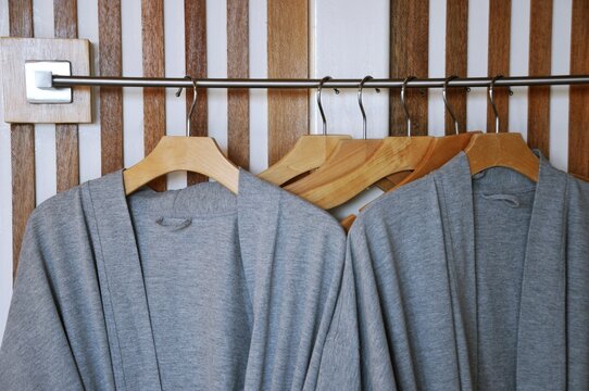 Bathrobe and Wooden Hangers in walk in closet