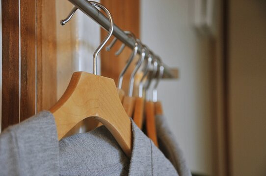 Bathrobe and Wooden Hangers in walk in closet