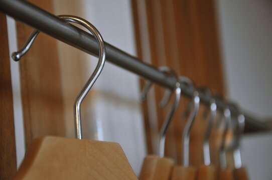Bathrobe and Wooden Hangers in walk in closet