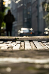 The Hague, Netherlands A person in silhouette walsk on an old cobblestoned street called Oude Molstraat.