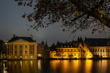 The Hague, Netherlands The Mauritzhuis Museum and the Dutch Parliament at night on the Hofvijver lake.