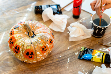 Children's painting class. Painting day with parents in class painting pumpkins.